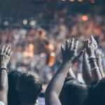 Churches - Group of People Raise Their Hands on Stadium