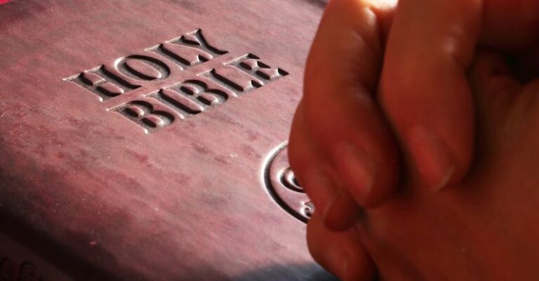 Churches - Person Hands on Holy Bible