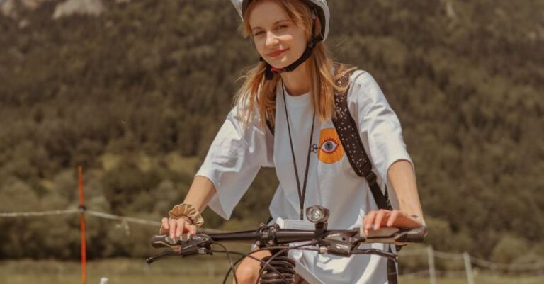 Ride-Sharing - A woman riding a bike on a dirt road