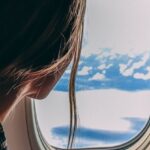 Air Travel - Person Holding Smartphone Riding Airplane