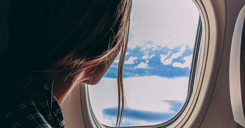 Air Travel - Person Holding Smartphone Riding Airplane
