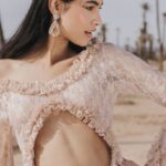 Fashion Outlets - A woman in a pink dress poses in the desert