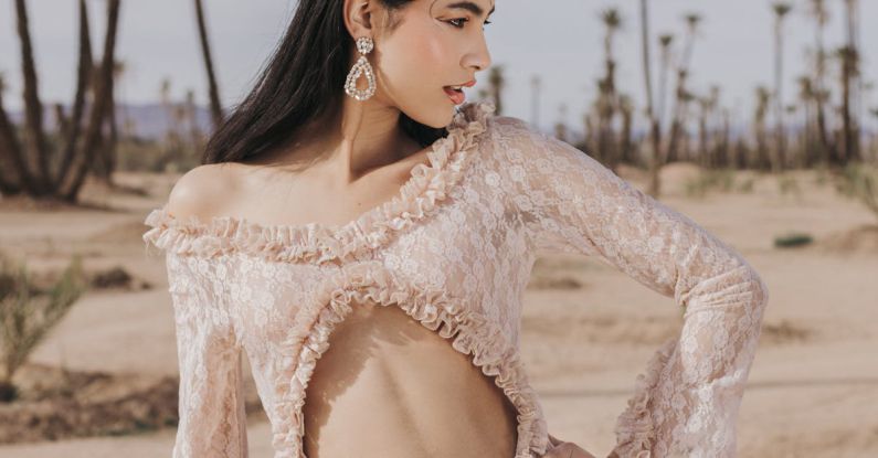 Fashion Outlets - A woman in a pink dress poses in the desert