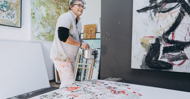 Artist Studios - A man painting in an art studio with a large painting