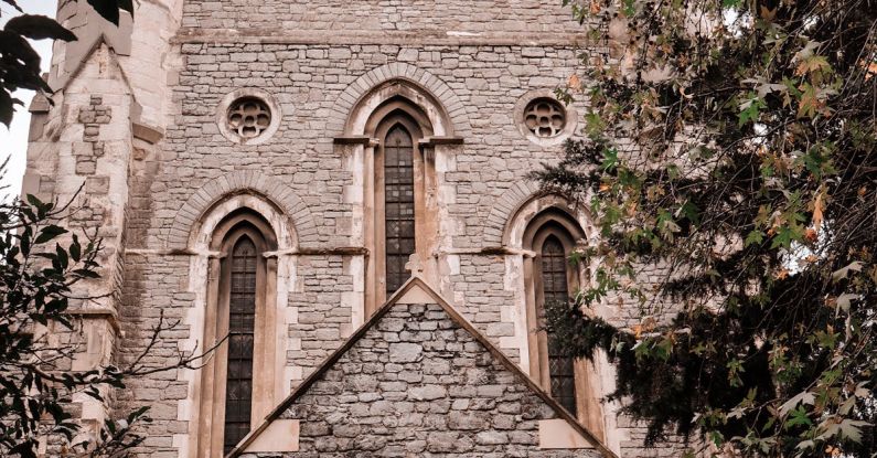 Memorials - A church with a tall tower and a tree